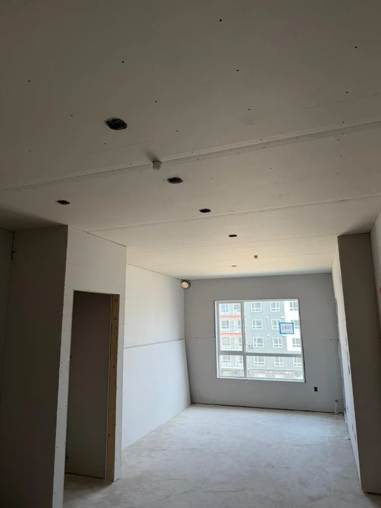 Complex wall framing with insulation, vapor barrier, and recessed lighting rough-in