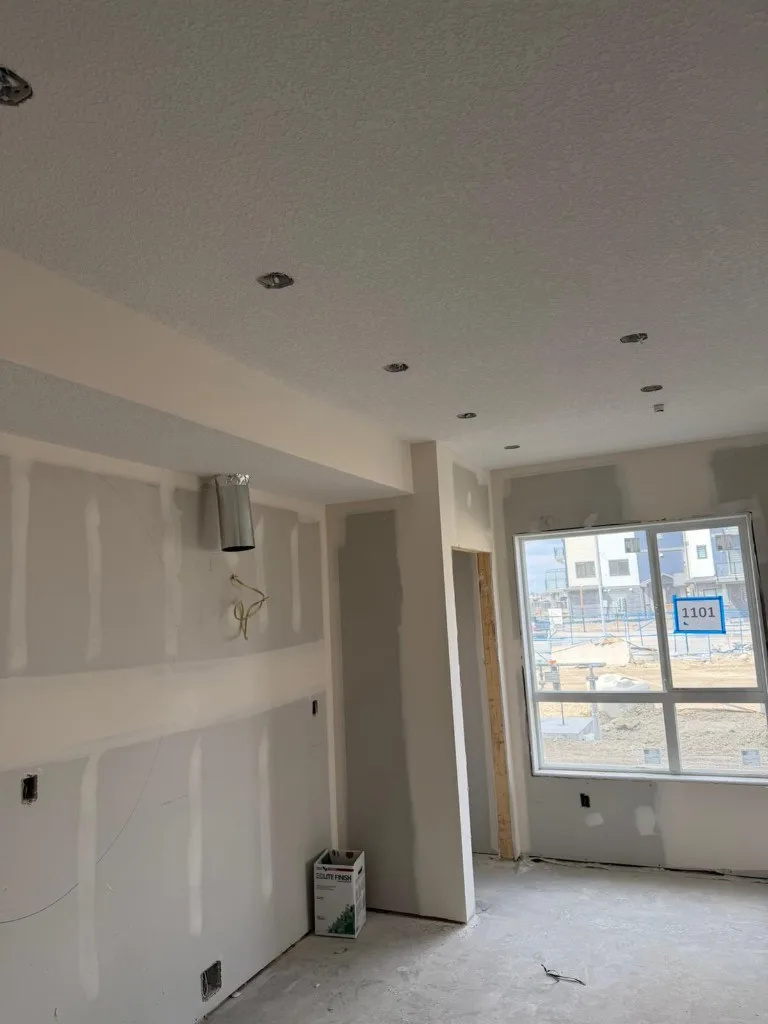 Room with grey drywall and fresh mud on all joints