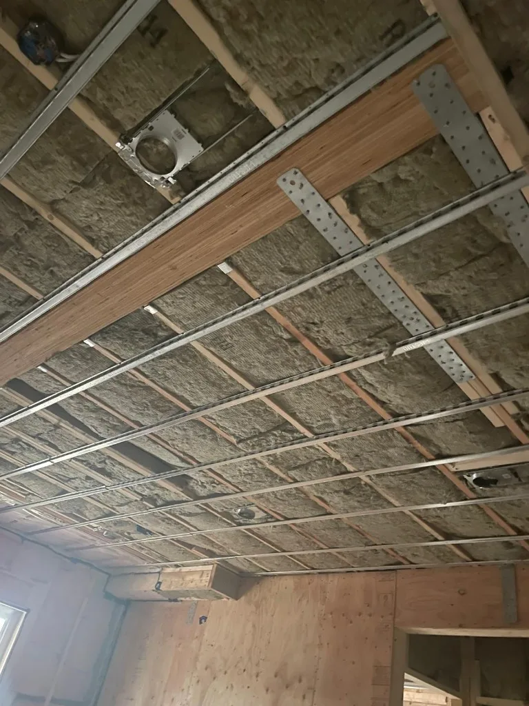 Wide commercial corridor with drywalled columns and soffits