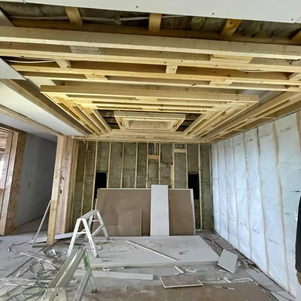 New construction interior with windows and taped drywall walls